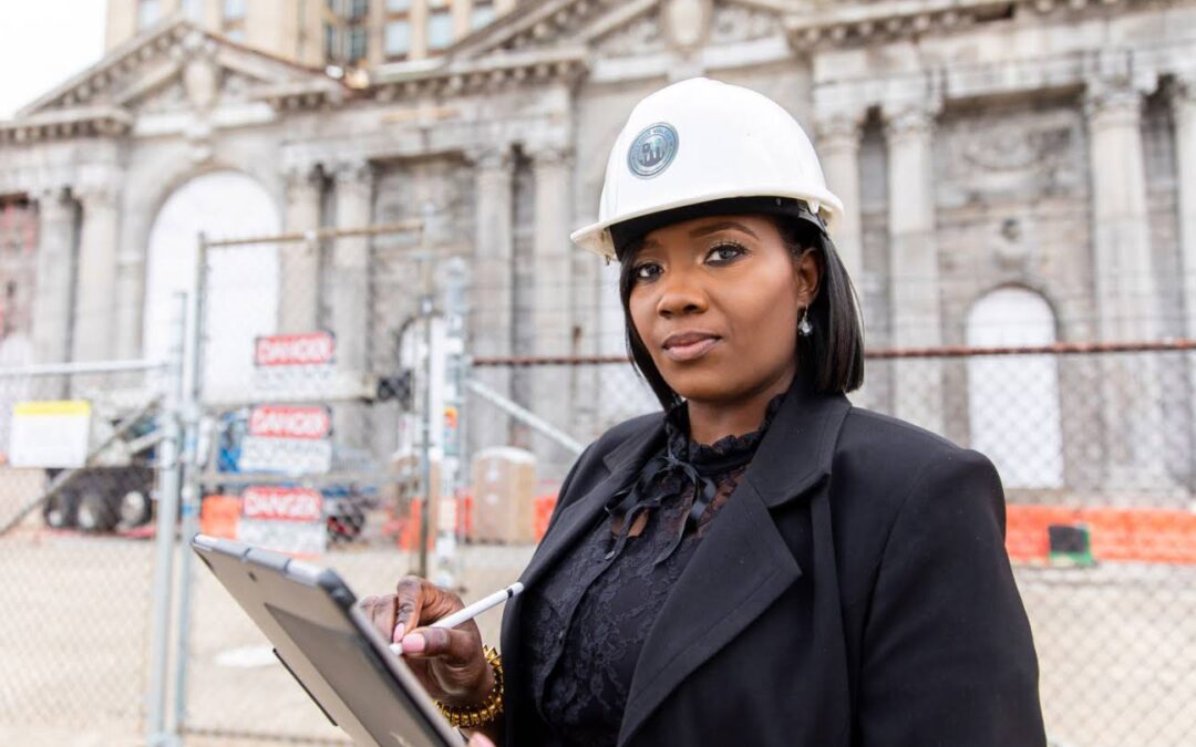 Woman in a hard hat and suit on a job site